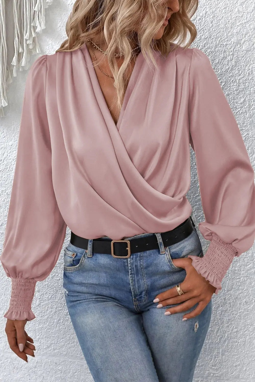 Light mauve surplice-neck lantern sleeve blouse with draped wrap front and puff cuffs.