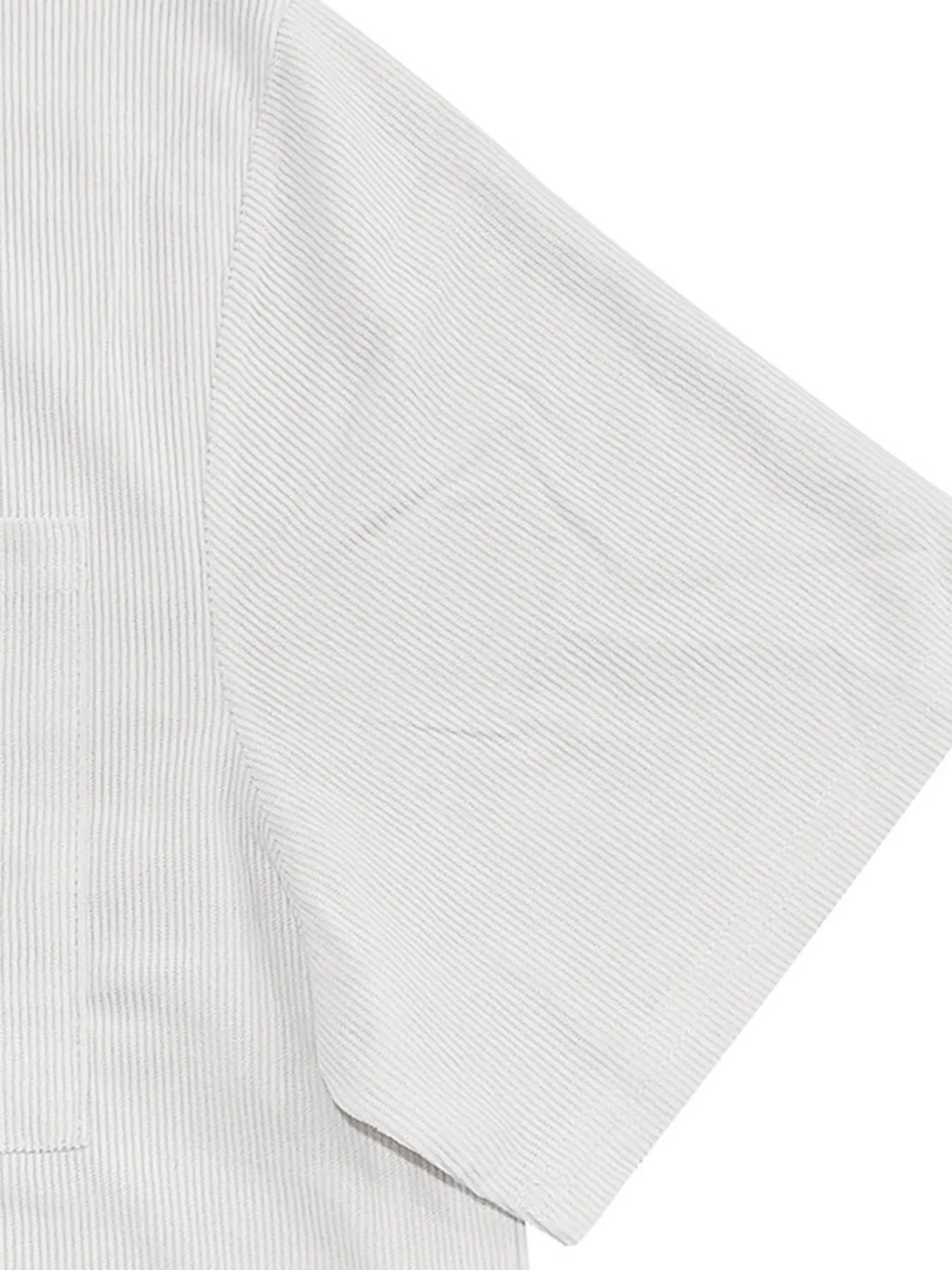 White shirt sleeve with ribbed cuff detail from the set