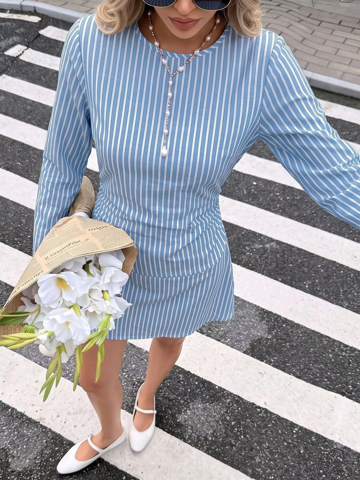 Blue-and-white striped long-sleeve mini dress with ruched waist detail.