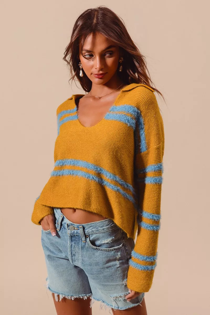 Mustard fuzzy striped sweater with deep U neck, long sleeves, and light blue bands