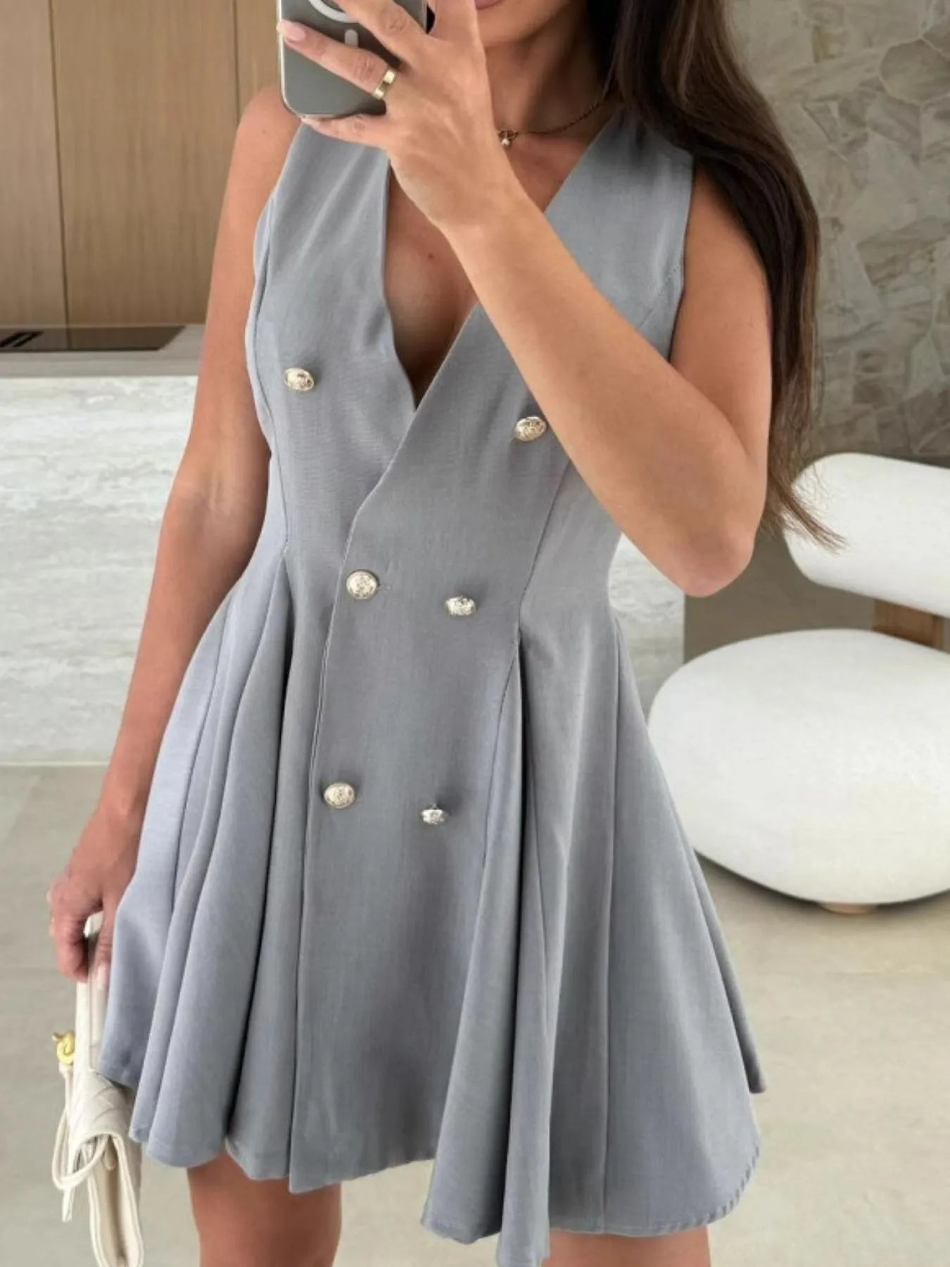 Sleeveless double-breasted mini dress in blue-gray with pleated skirt and gold-tone decorative buttons