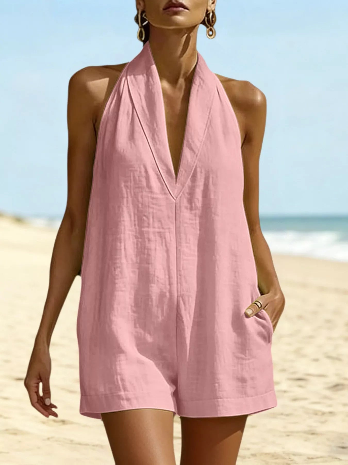 Pink halter-neck romper with V neckline and front pockets, short legs