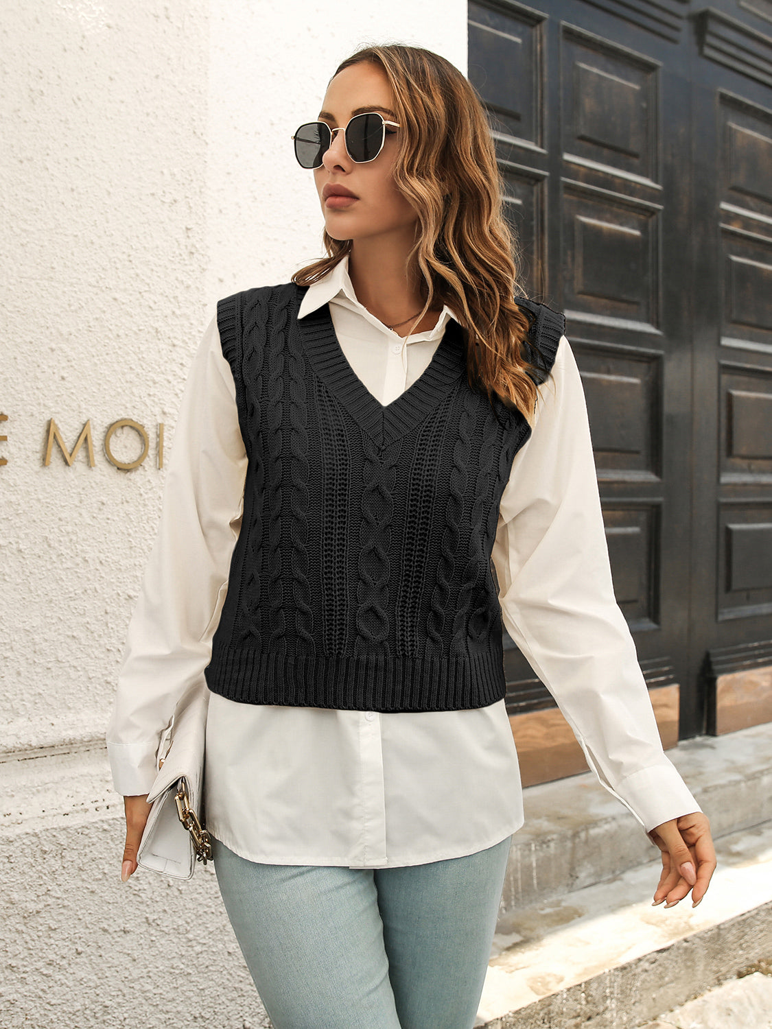 Black V-neck textured knit sweater vest, sleeveless with ribbed neckline