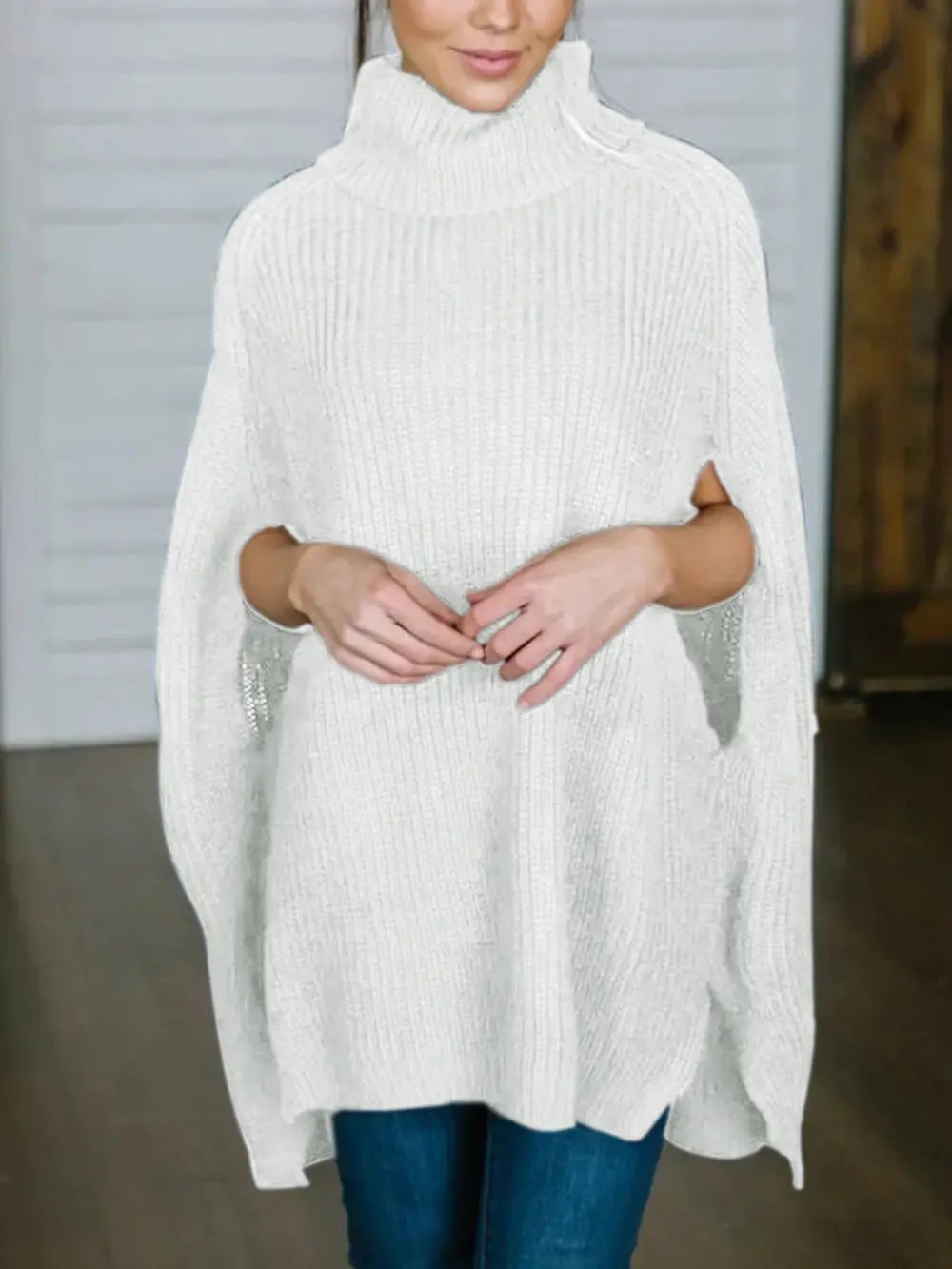 White turtleneck slit sweater with chunky rib knit, draped shoulders and side hem split.