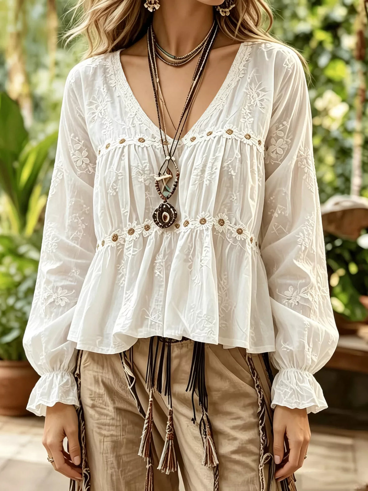 White embroidered V-neck ruffle peplum top with gathered long sleeves and eyelet details