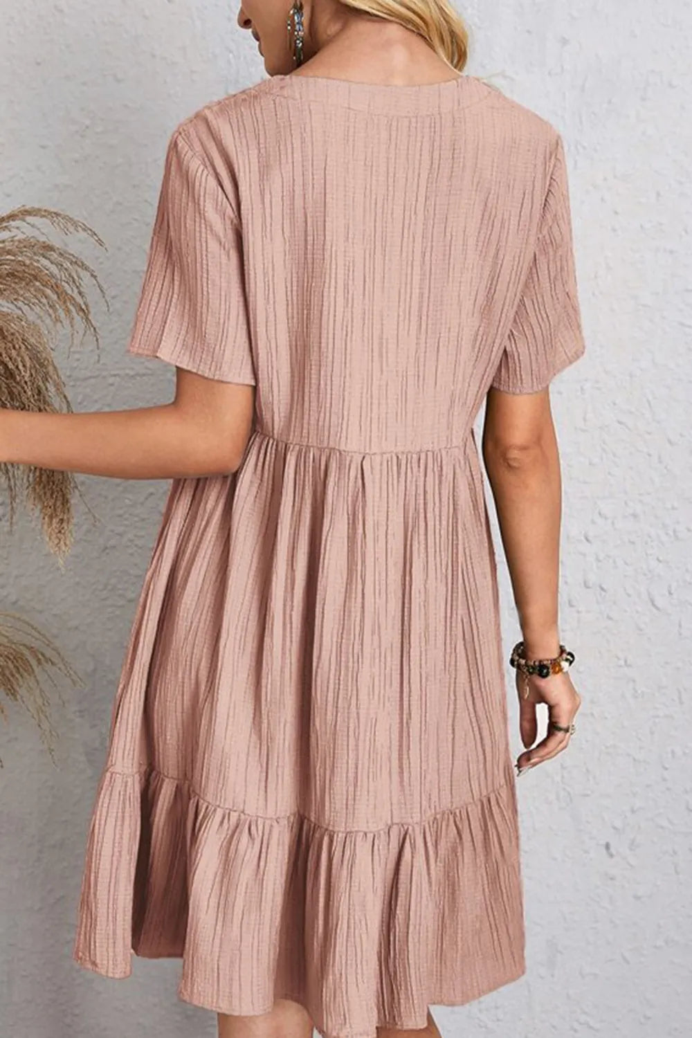 Back view dusty pink ruched V-neck short-sleeve tiered dress with gathered waist