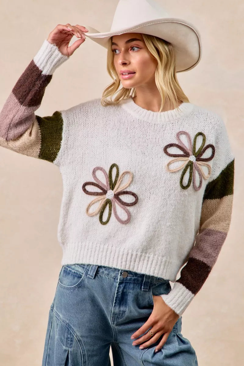 Ivory flower color block sweater with three embroidered flowers and striped sleeve panels