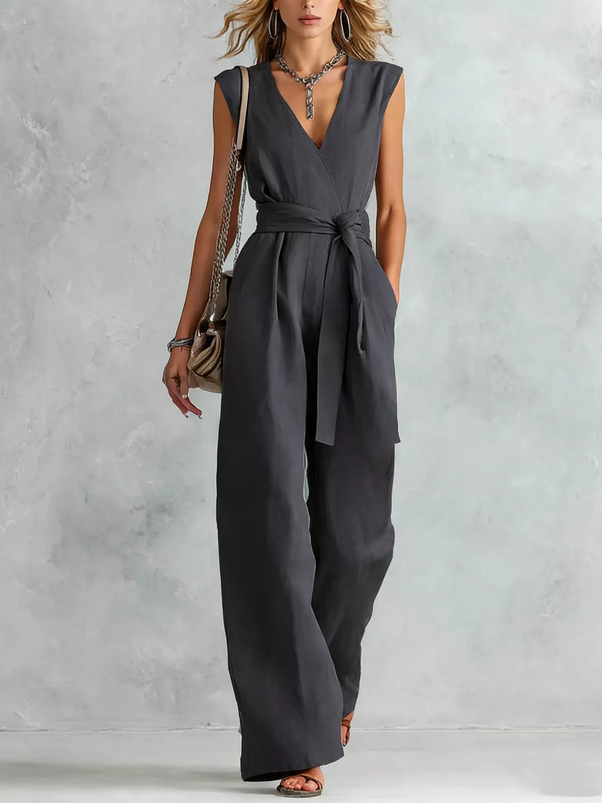 Dark gray sleeveless wide-leg jumpsuit with V-neck and waist tie