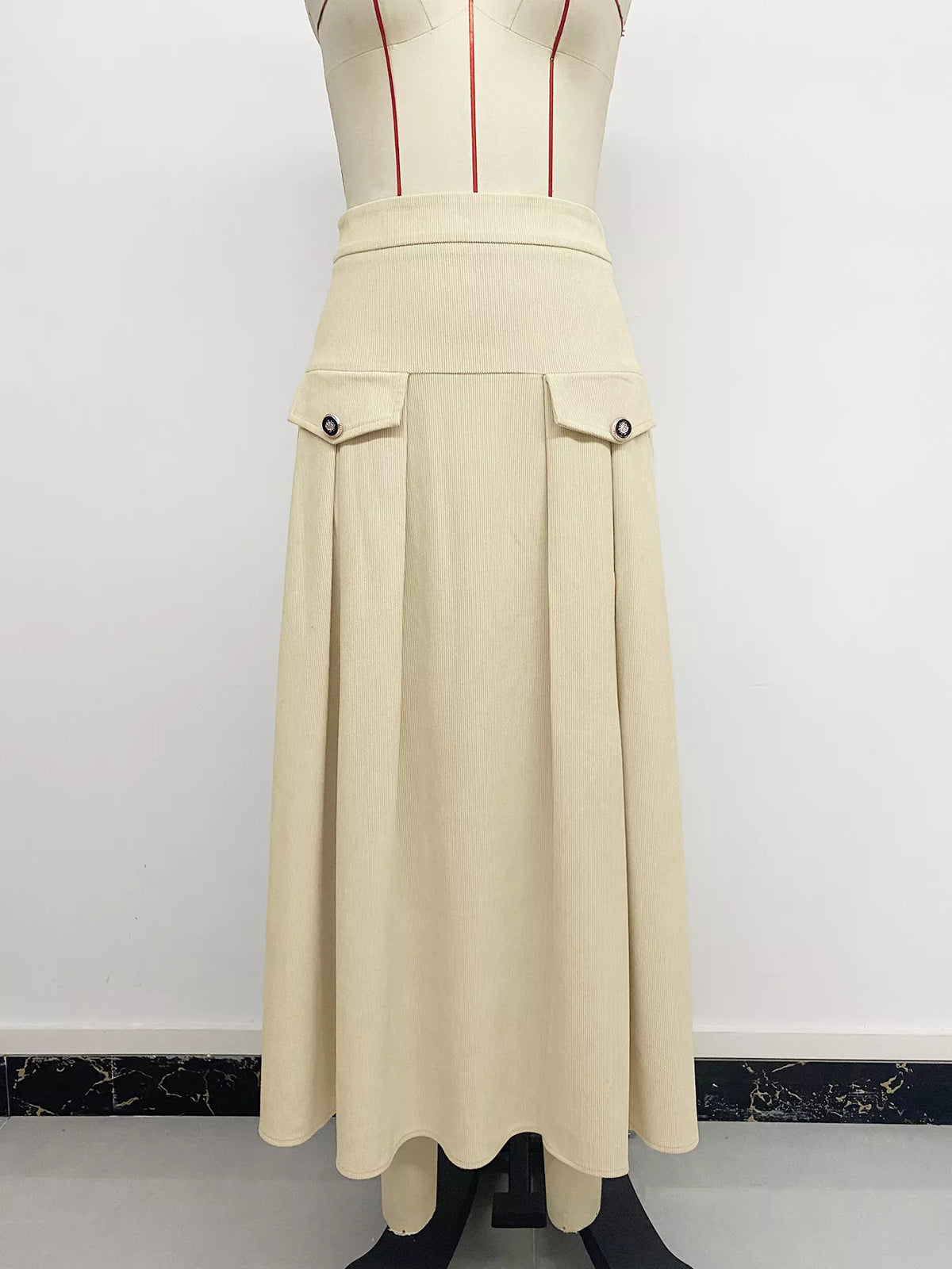 Khaki pleated midi skirt with high waist, front flap pockets, and zipper placket