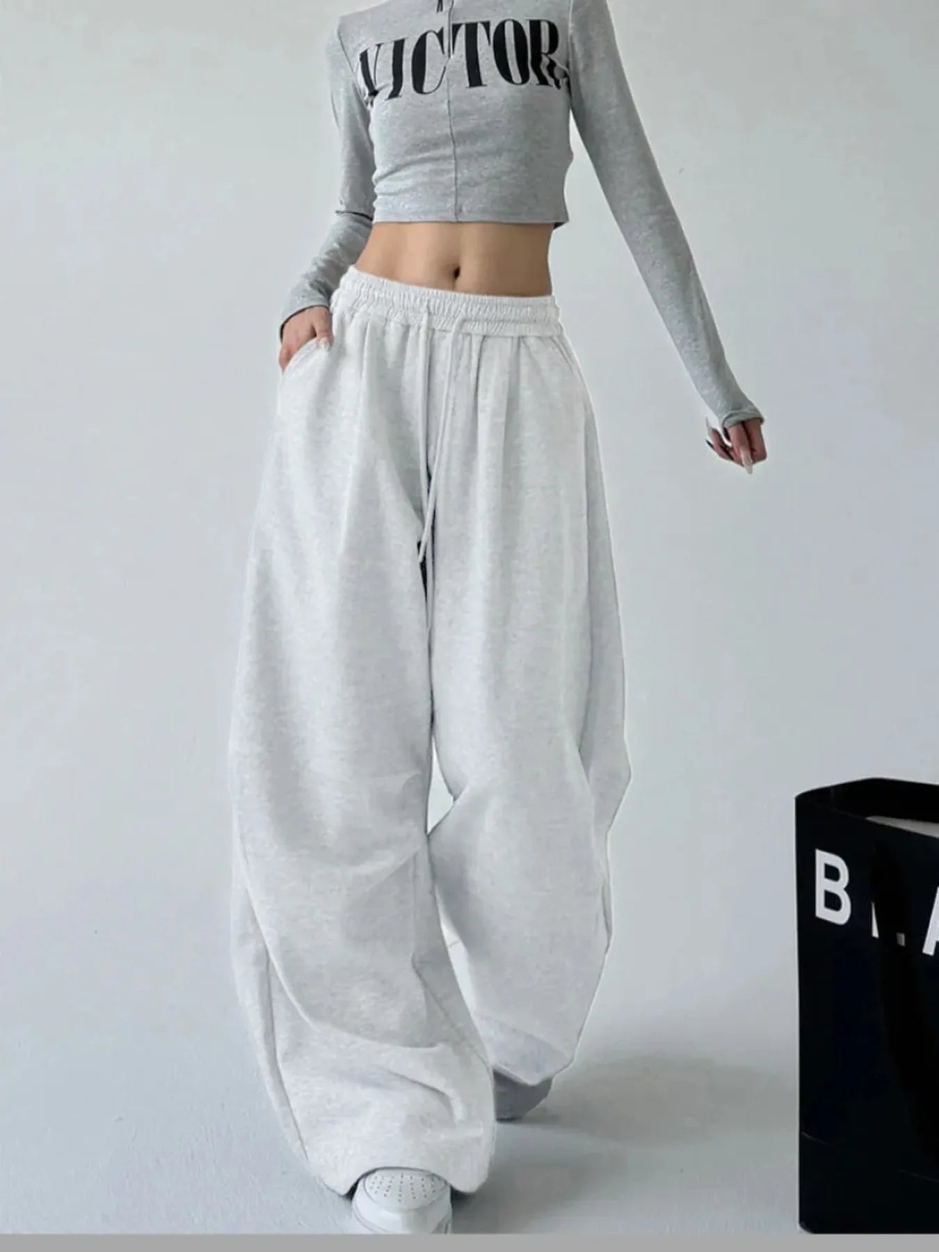 White oversized wide-leg drawstring pants with elastic waistband and gathered cuffs