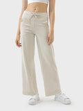 Cream drawstring active pants with side pockets and wide straight legs