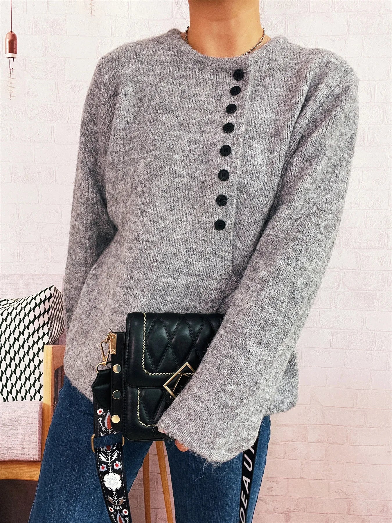 Gray button-front side-tie sweater with long sleeves and black button placket