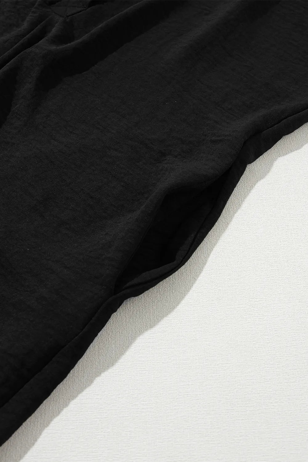Black romper shorts hem and side seam detail