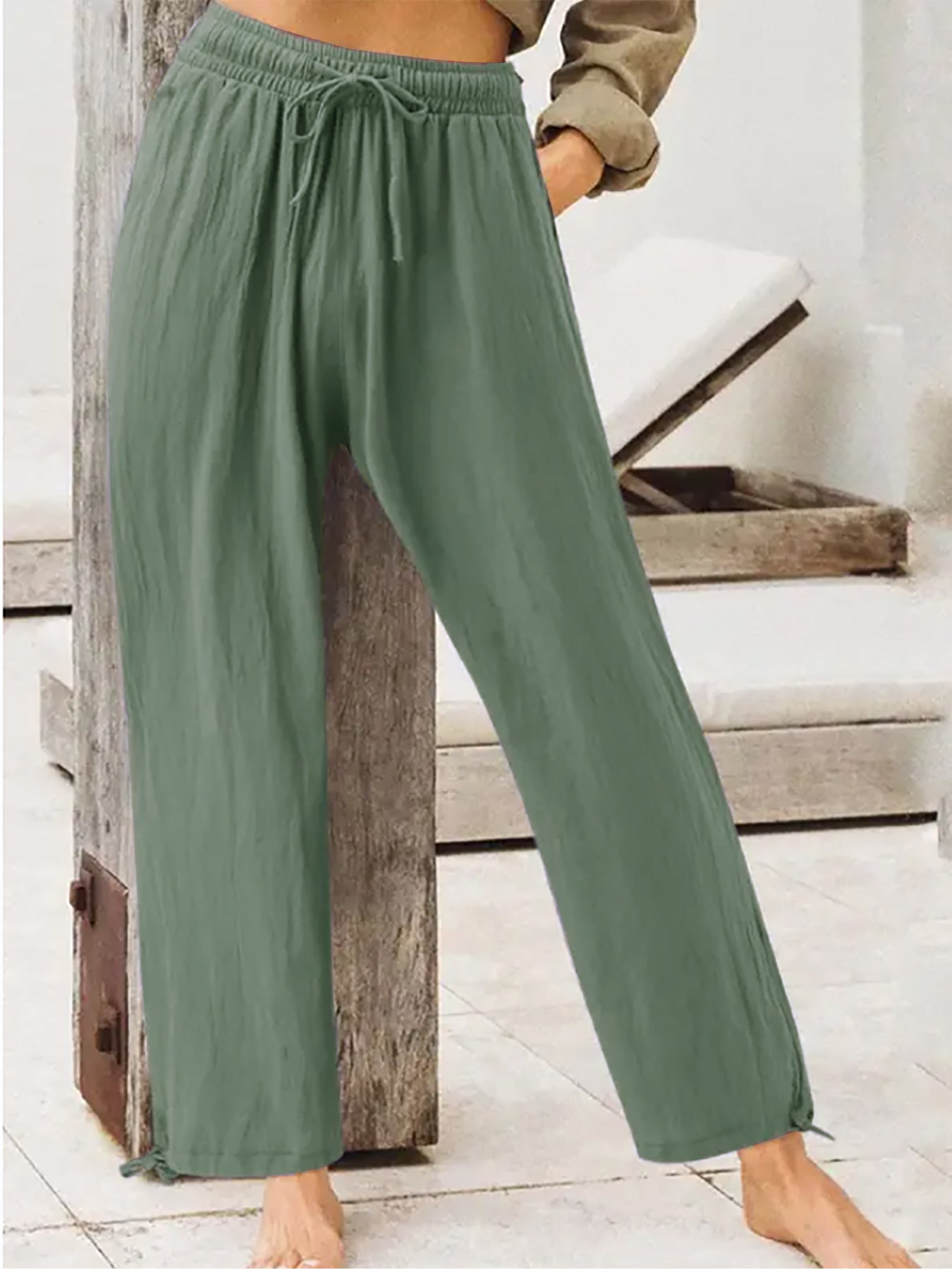 Sage green wide-leg drawstring pants with elastic waist and relaxed flowy legs