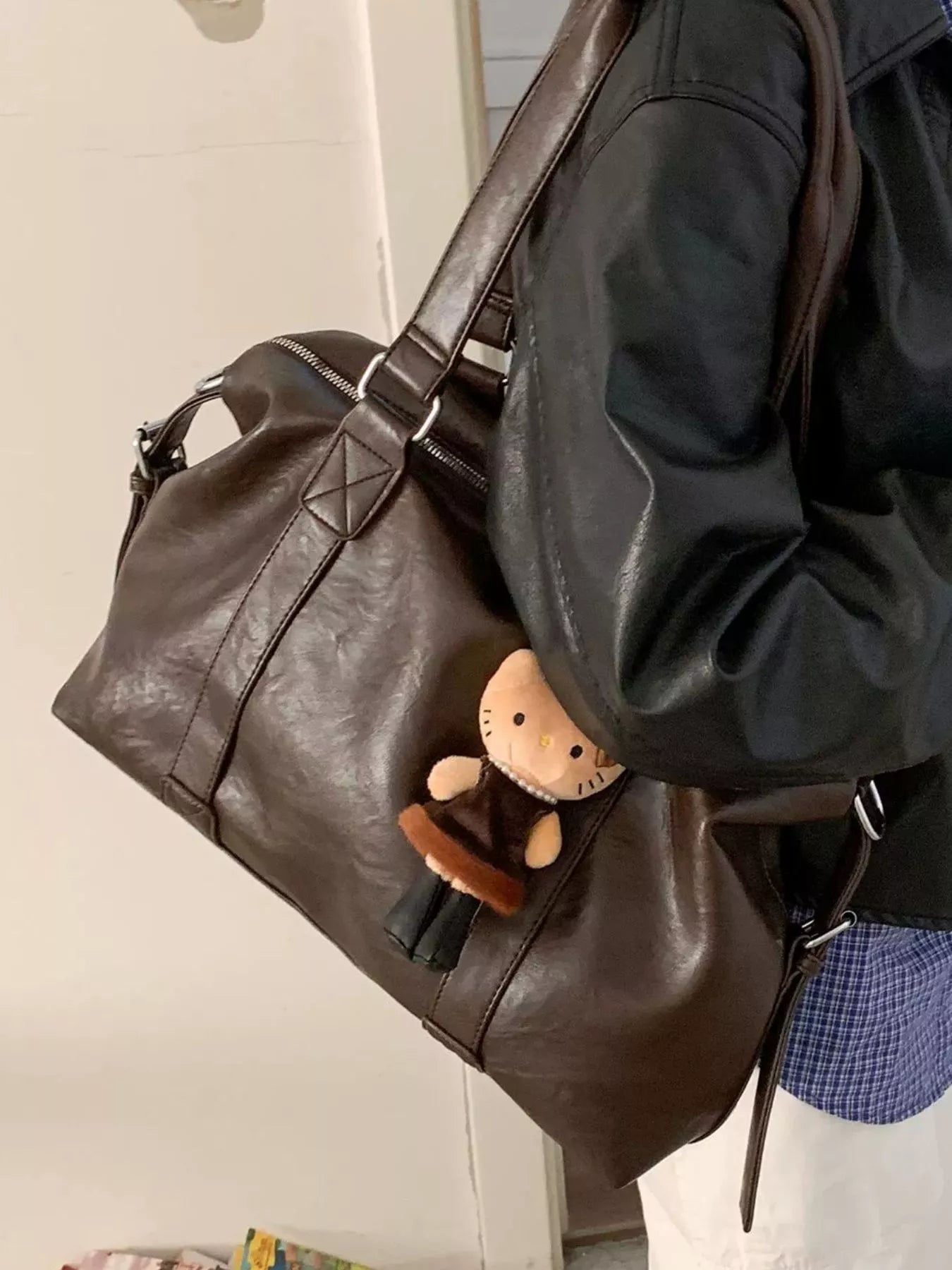 PU leather shoulder bag in dark brown with plush charm