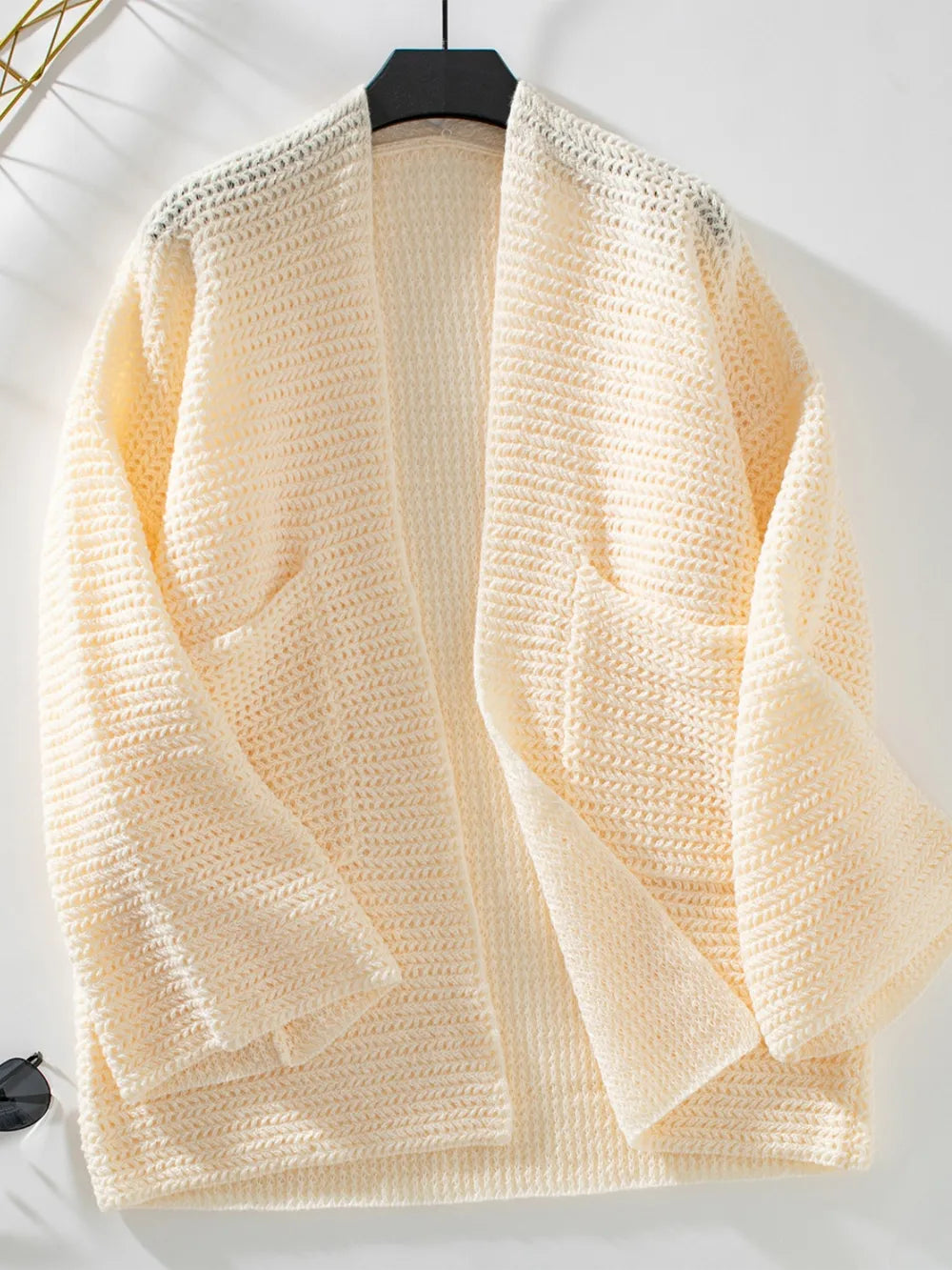 Cream open-front long sleeve cardigan on hanger, textured knit with patch pockets