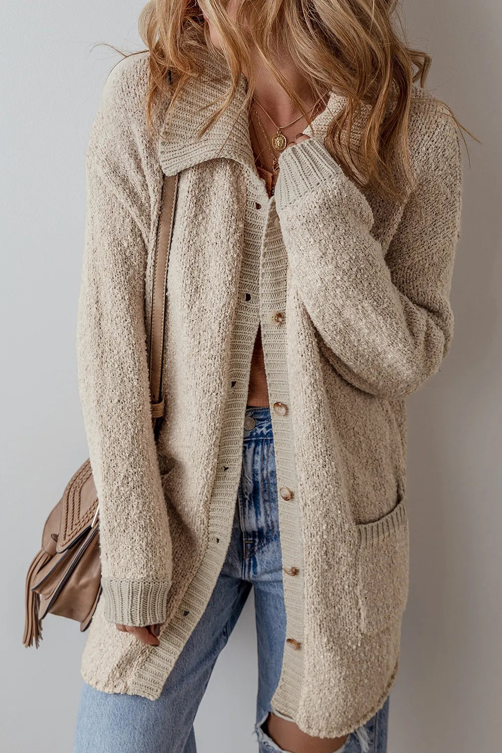 Dust Storm button-up long sleeve cardigan with patch pockets, worn open over shirt
