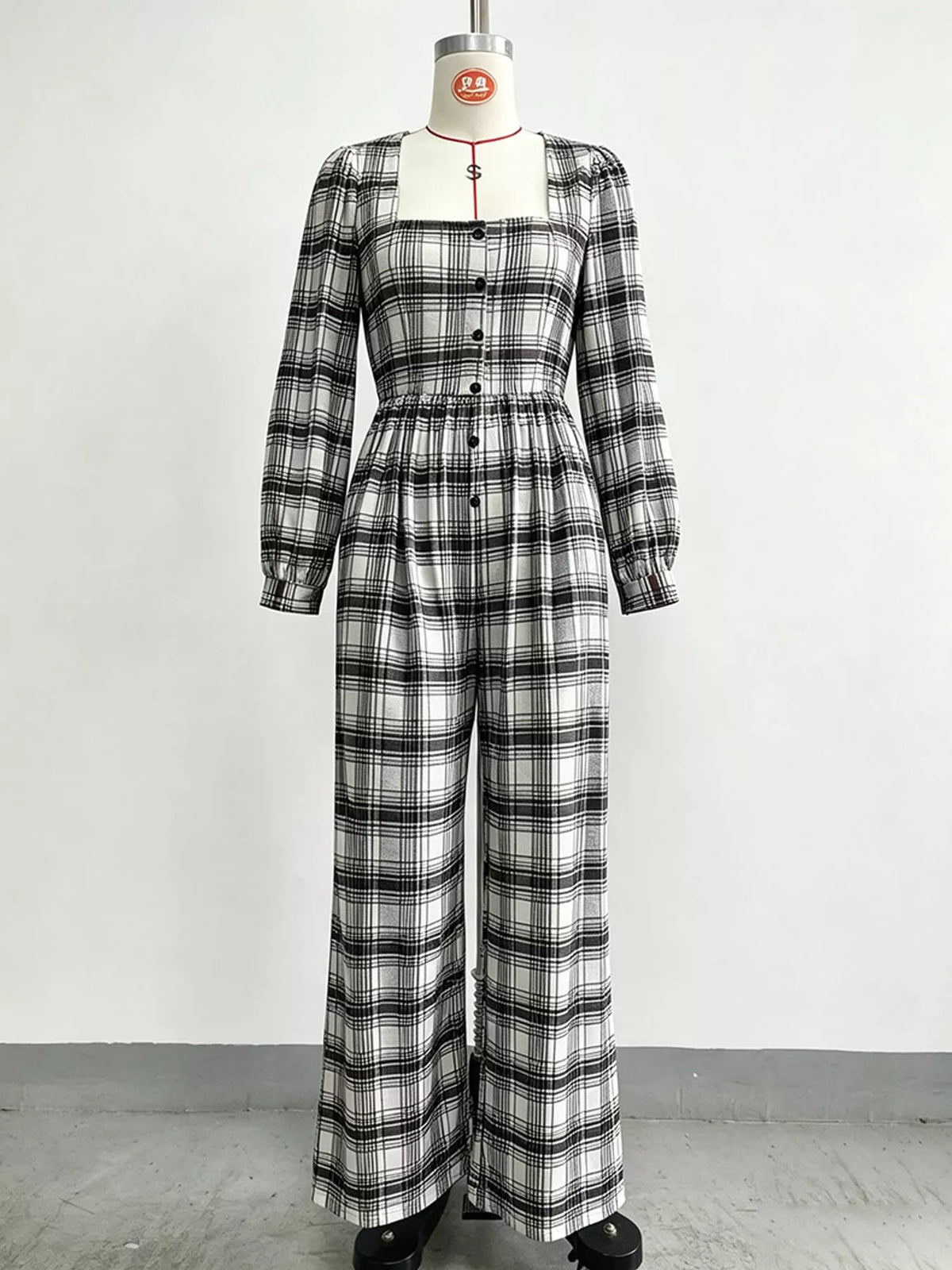 Plaid square-neck long-sleeve jumpsuit with button front and wide legs, black and white
