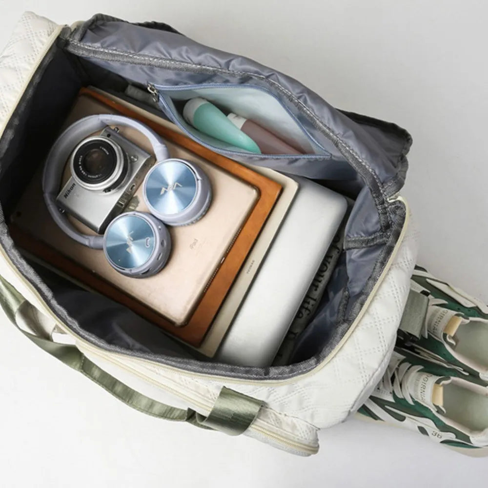 White duffel bag interior with open accessory compartments and padded lining