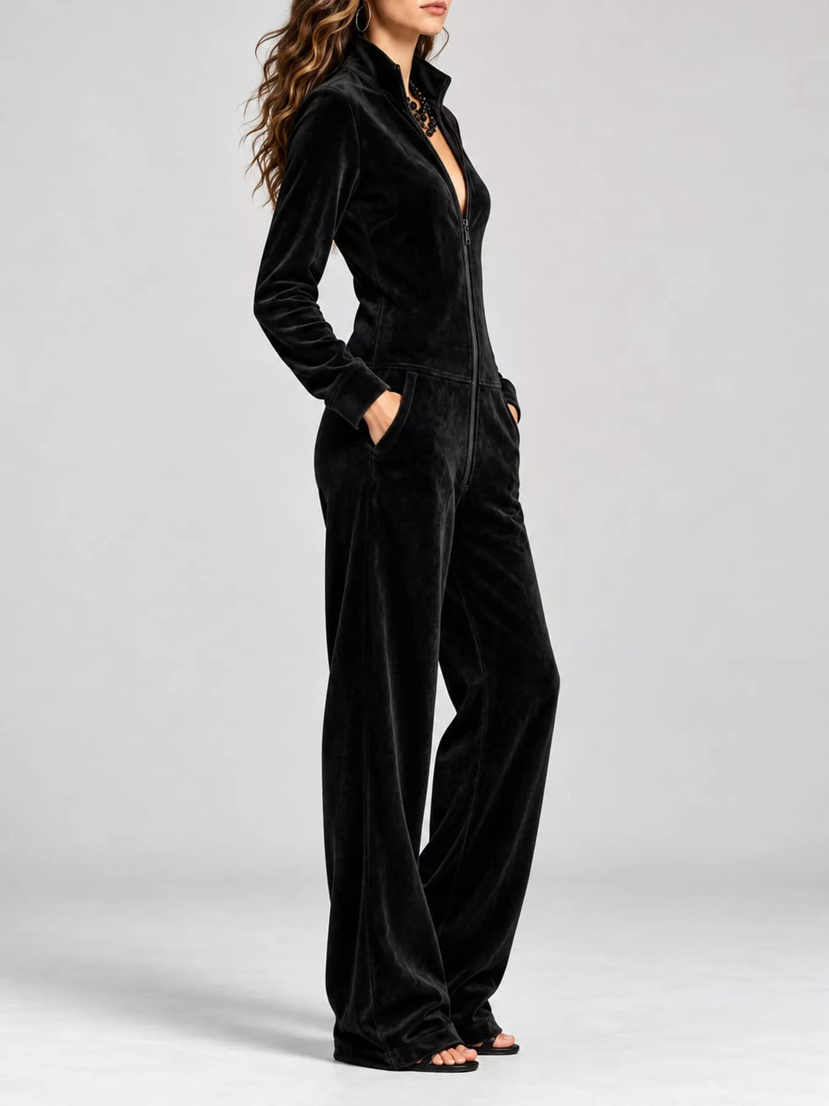 Black velour zip-front jumpsuit with side pockets and long sleeves, wide-leg