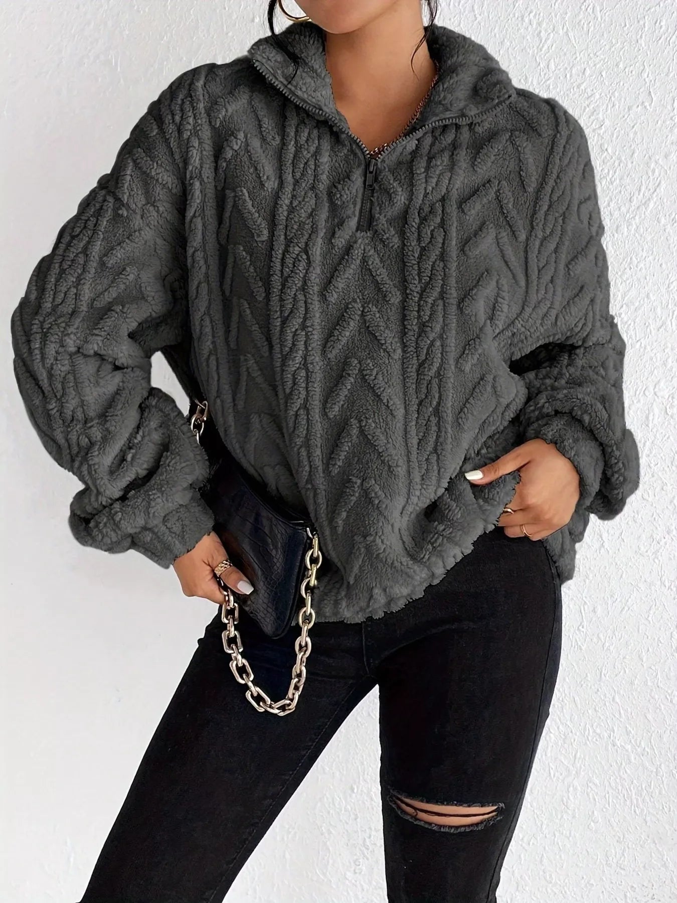 Dark gray sherpa quarter-zip sweatshirt with cable-knit texture and dropped shoulders