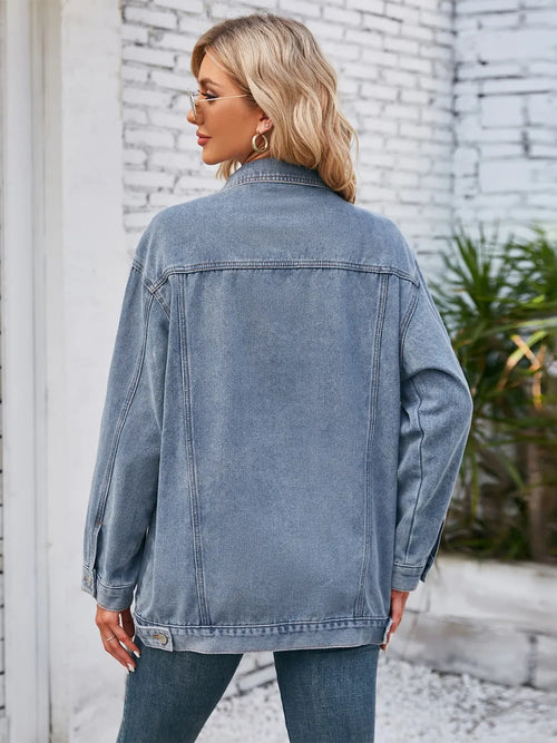 Dusty blue denim jacket worn open at back with button closure, long sleeves