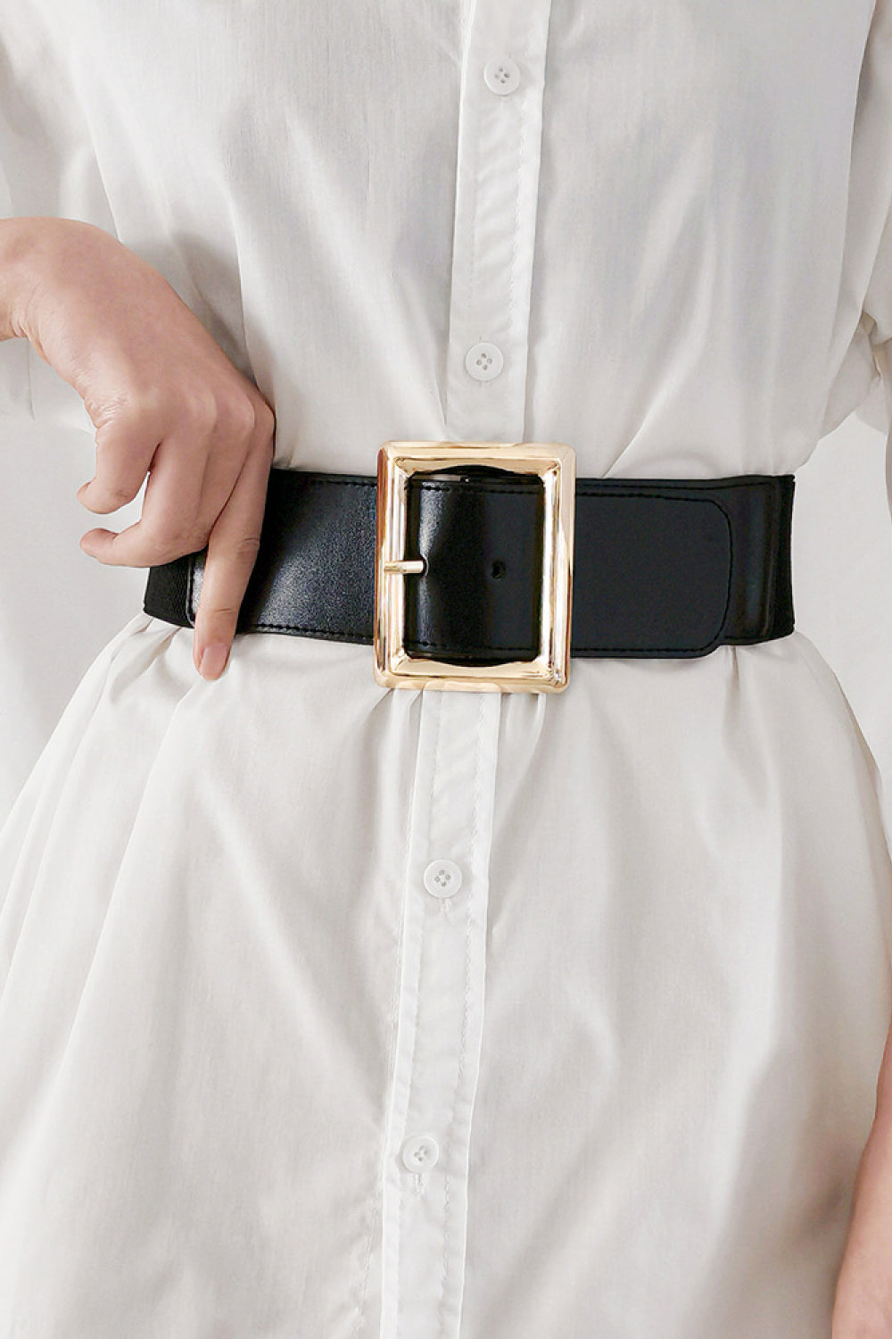 Black wide elastic belt with rectangle buckle and gold tone square frame.
