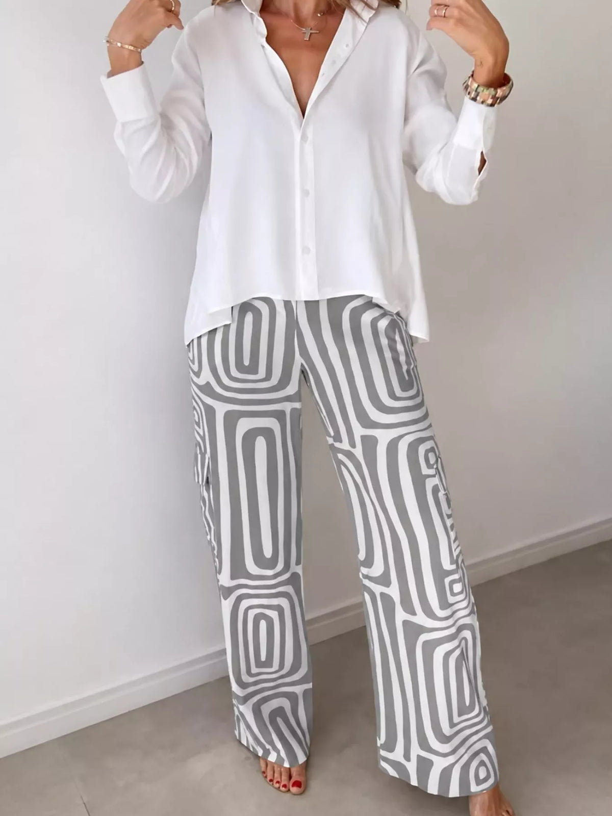 Button-down shirt and geometric patterned pants set in white with gray abstract print.