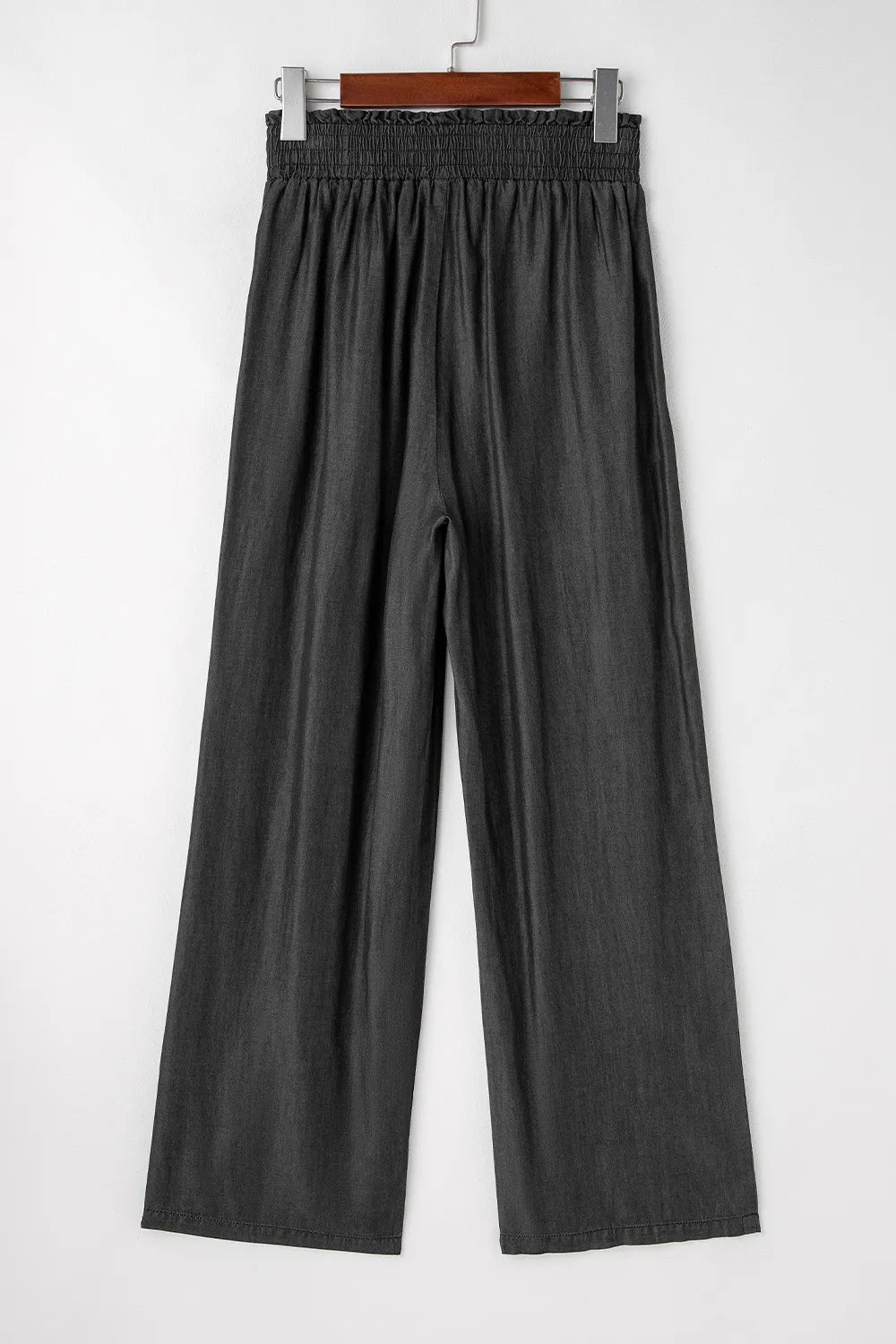 Black wide-leg pants with smocked waistband and gathered pleats