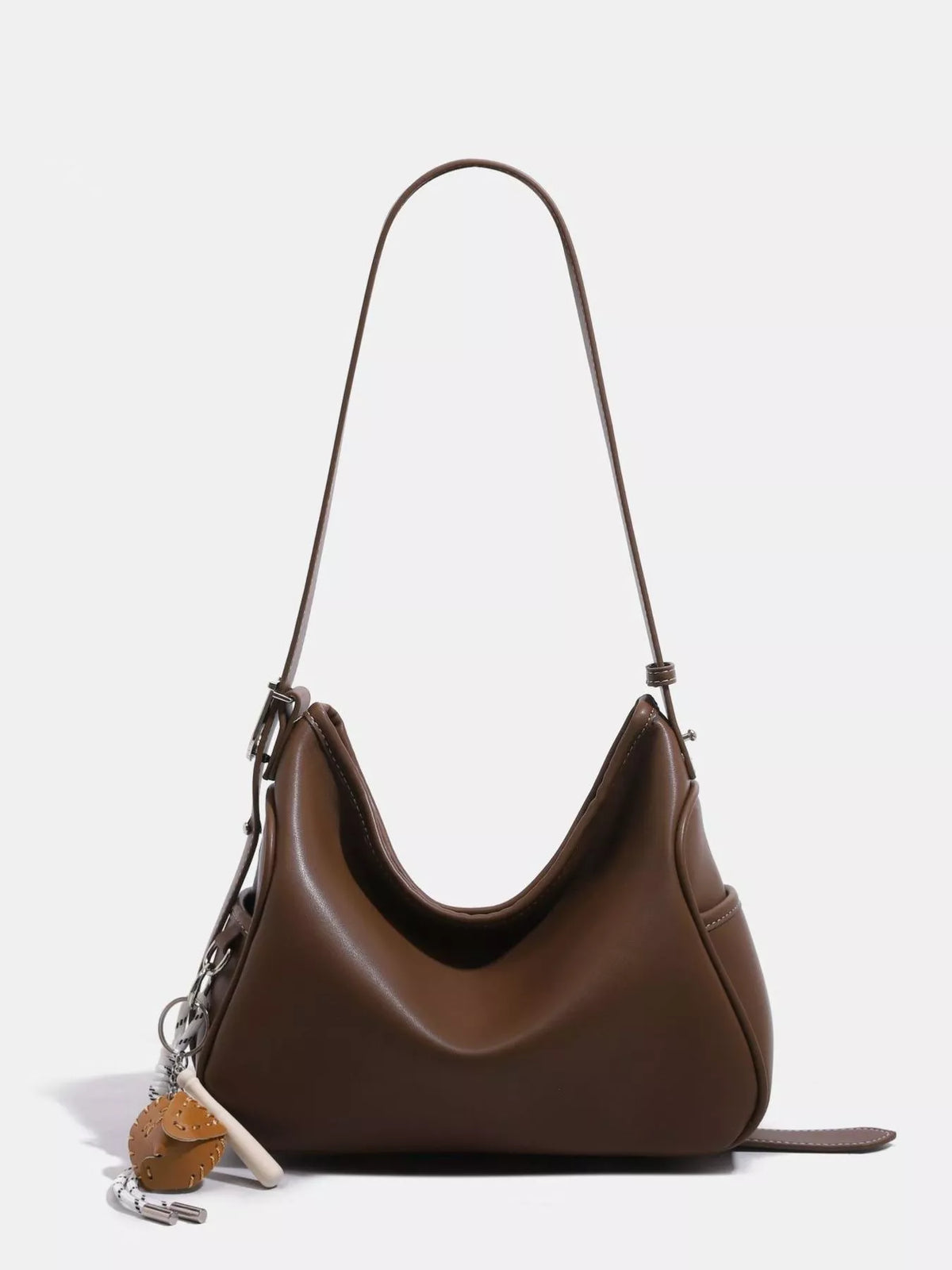 Brown slouchy vegan leather hobo shoulder bag with curved opening and chain charm