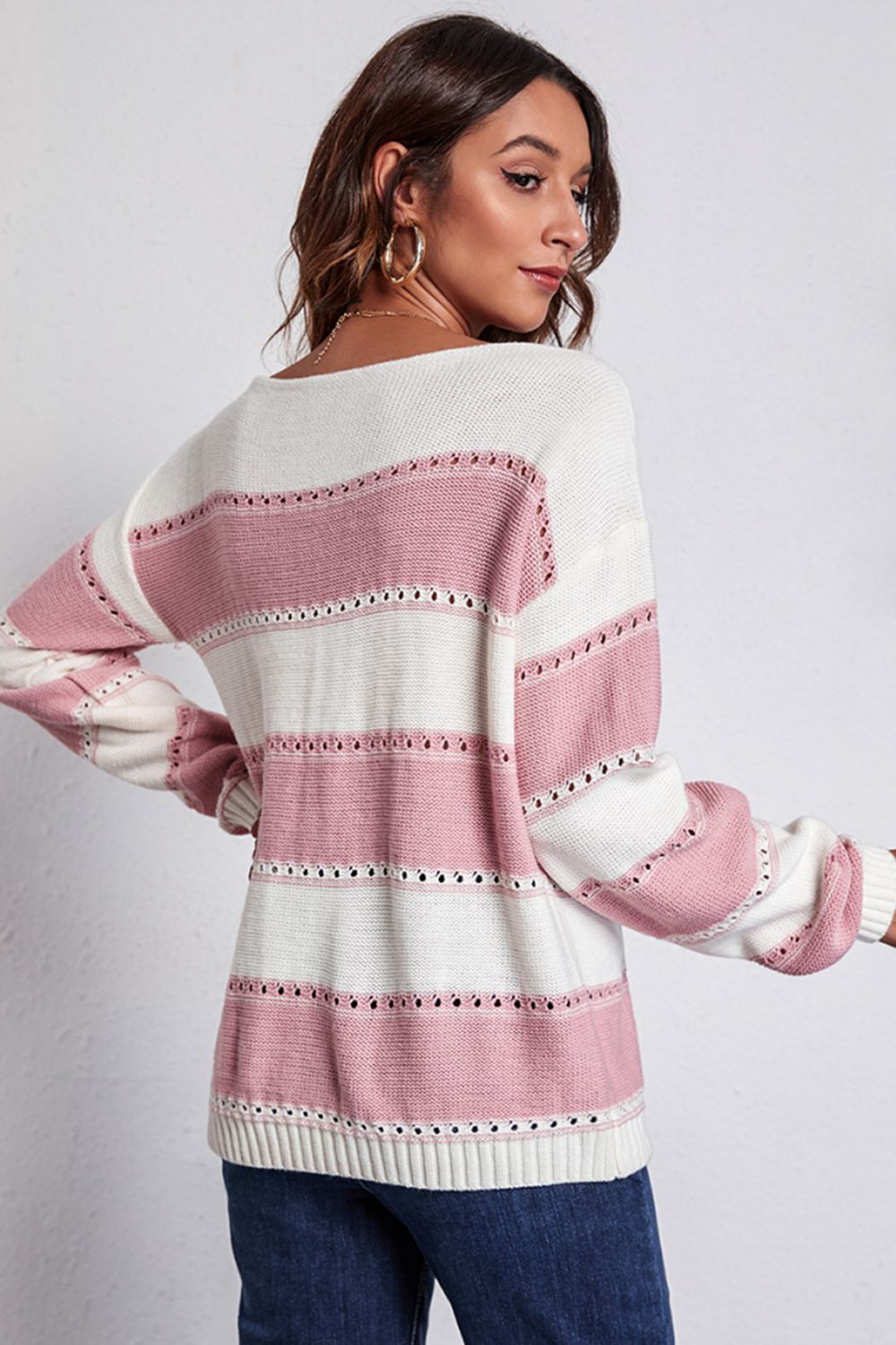 Blush pink and white striped boat neck dropped shoulder sweater, back view