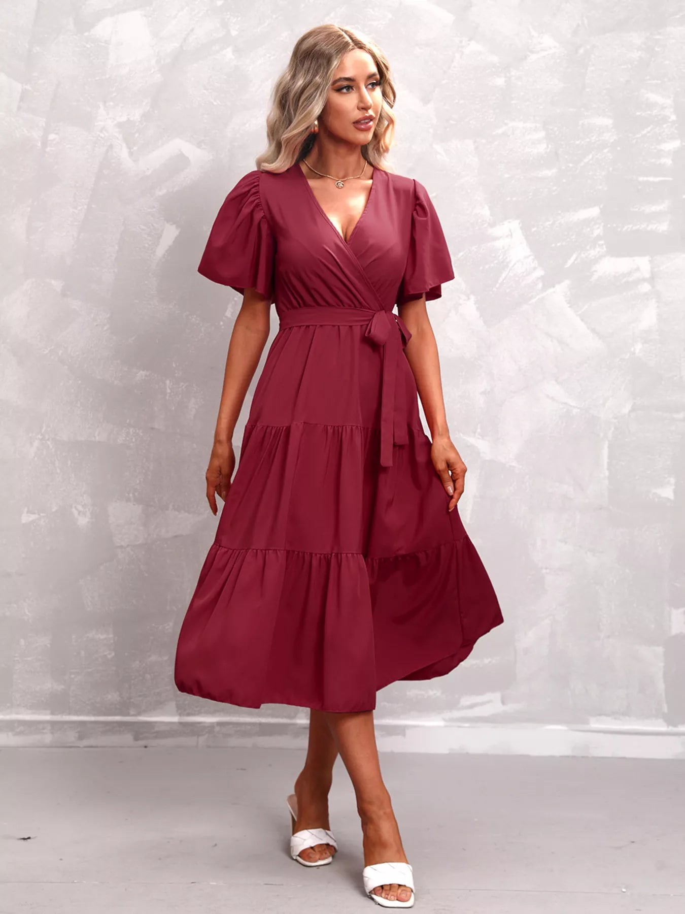 Burgundy flutter sleeve tiered midi dress with V-neck and tie waist, front view