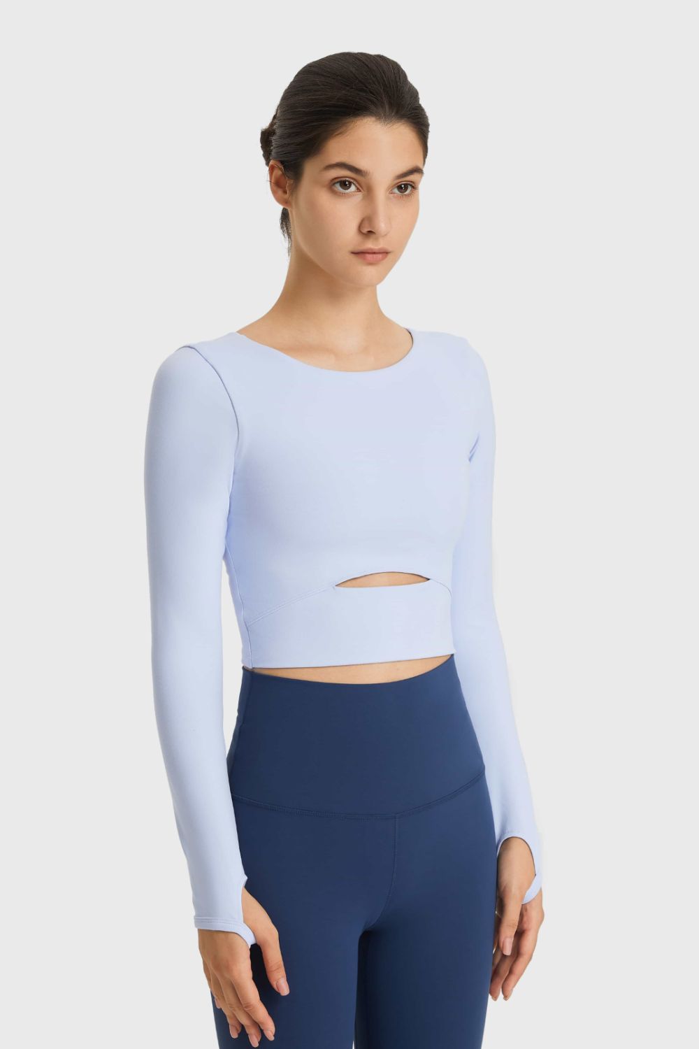 Light blue long-sleeve cropped sports top with waist cutout, front view