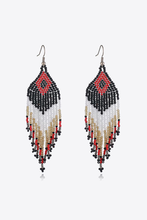 Beaded dangle earrings in black and white with red diamond center and gold accents