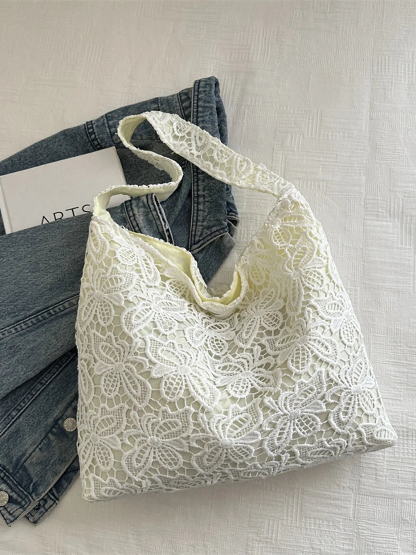 White lace shoulder bag with floral openwork pattern and wide tote shape