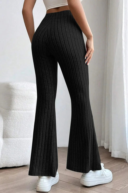 Ribbed high-waist flare pants in black, side view showing long wide-leg silhouette.