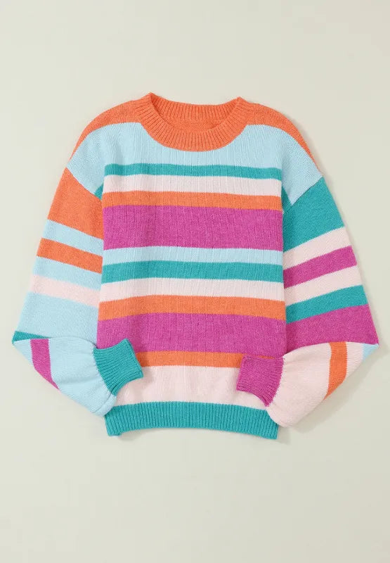 Folded striped round-neck sweater on plain background, multicolor bands and ribbed cuffs.