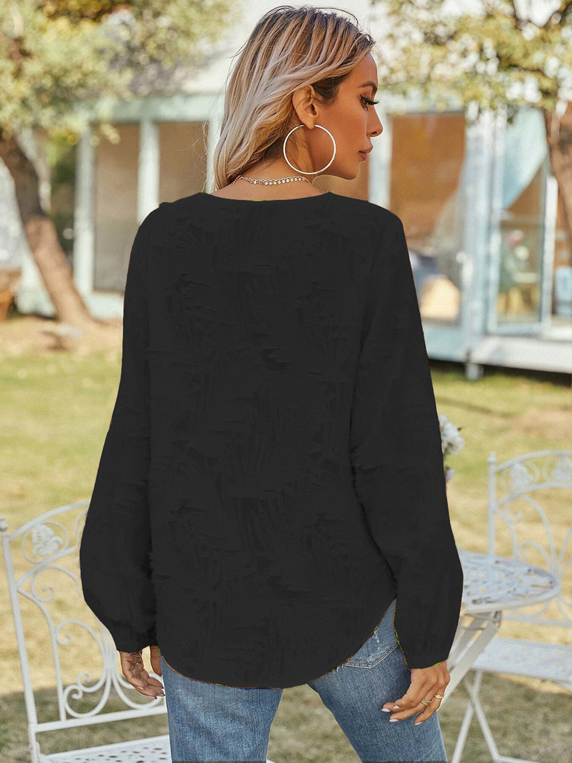 Black V-neck long-sleeve blouse with puff sleeves, round back hem