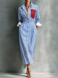 Blue striped shirt dress with red contrast pocket and button-front, midi length.