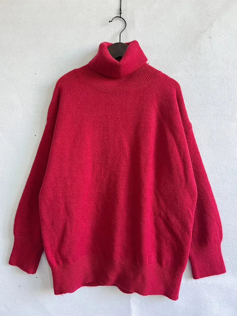 Red turtleneck long sleeve sweater on hanger, ribbed collar