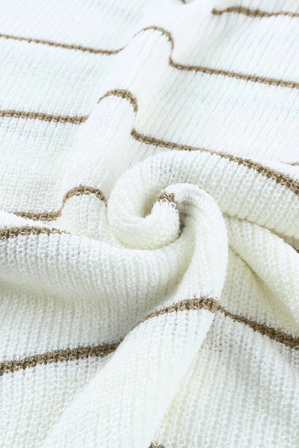 Close-up of white knit fabric with tan stripes and gathered cuff detail