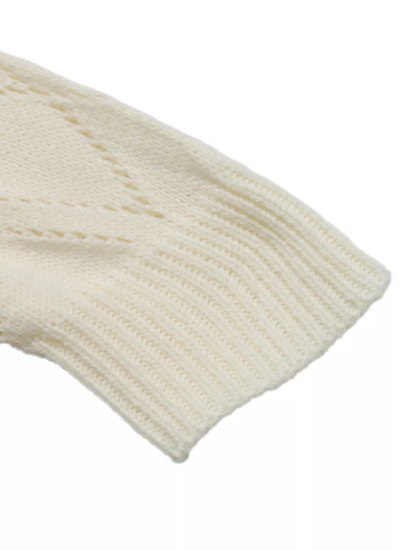 Ivory ribbed sweater cuff at the end of a long sleeve
