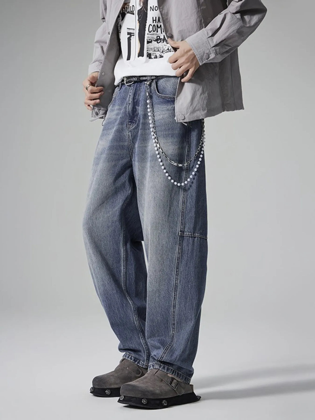Wide-leg washed denim jeans in blue with front pockets and silver chain detail