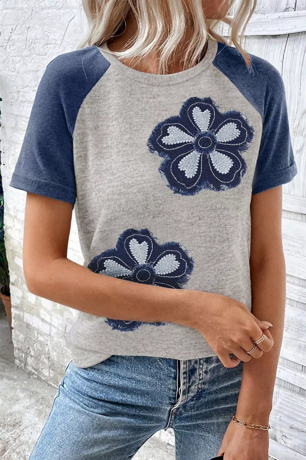 Cedar & Moore Floral Raglan Sleeve T-Shirt in light gray with navy sleeves and large blue embroidered flowers.