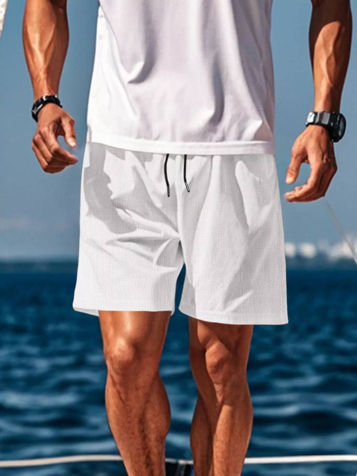 White drawstring shorts with side pockets and elastic waistband, relaxed straight fit