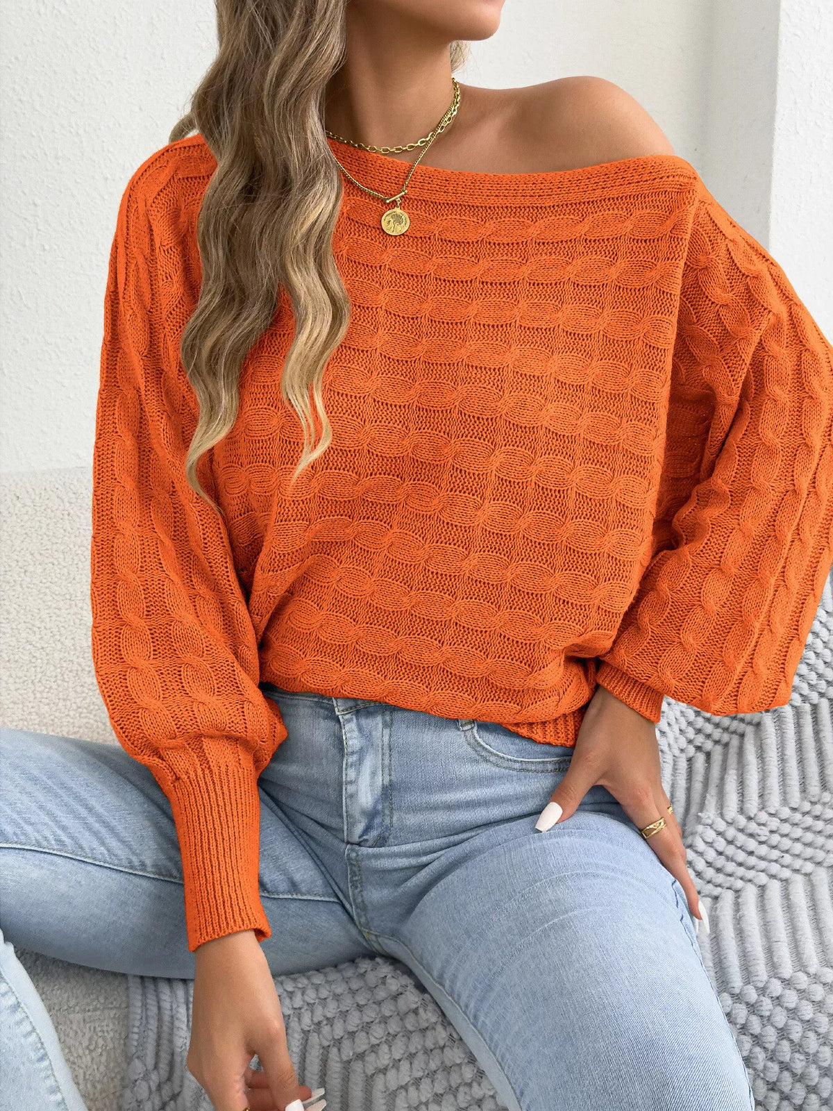 Orange cable knit boat-neck stretch sweater with textured stitch and ribbed hem