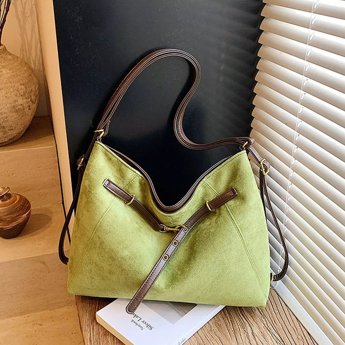 Medium green suede shoulder bag with brown contrast straps and gold-tone hardware