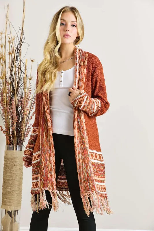 Rust aztec border cardigan with fringe hem and patterned cuffs, draped open