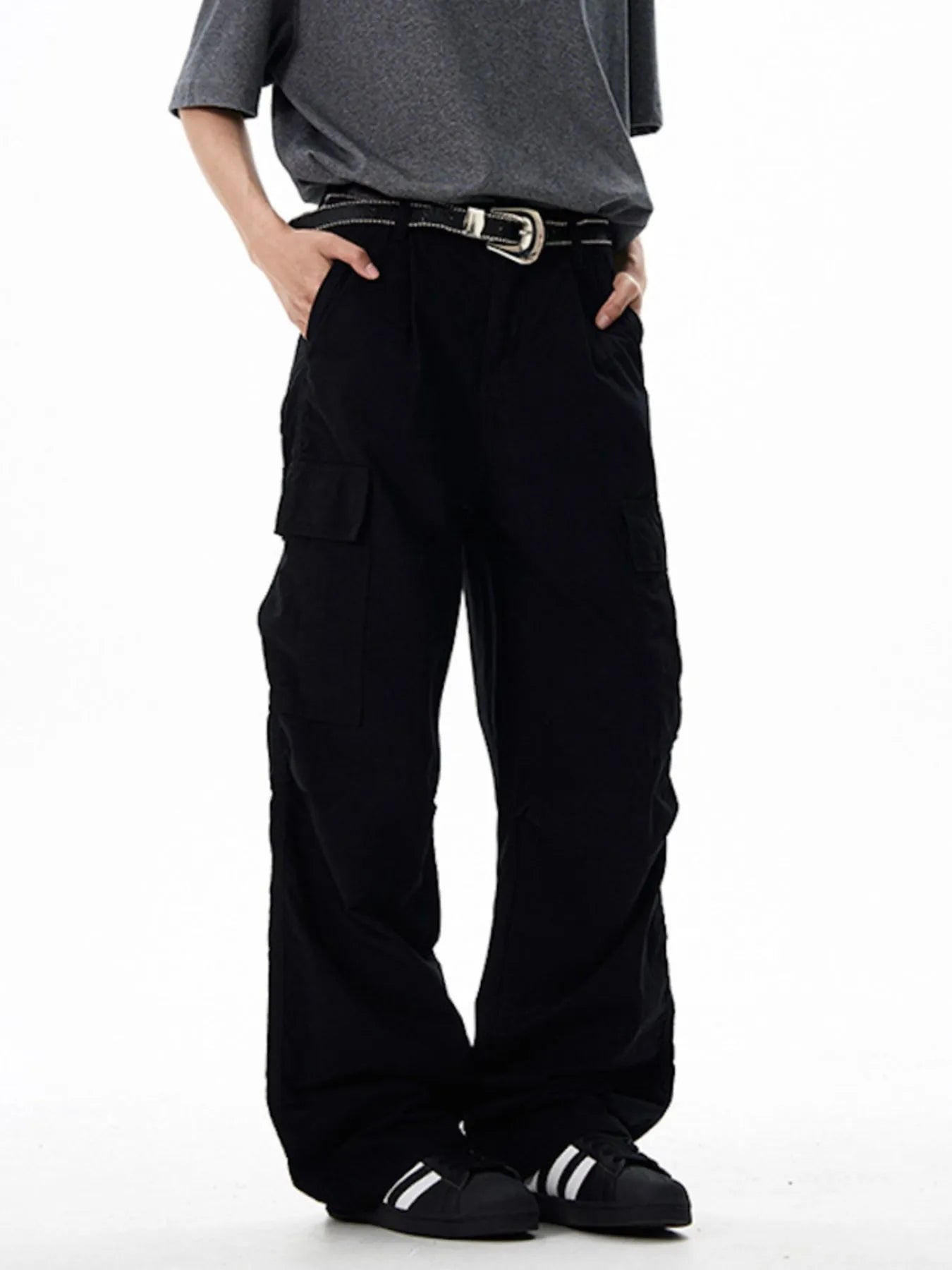 Black wide-leg cargo pants with front flap pockets and adjustable belt