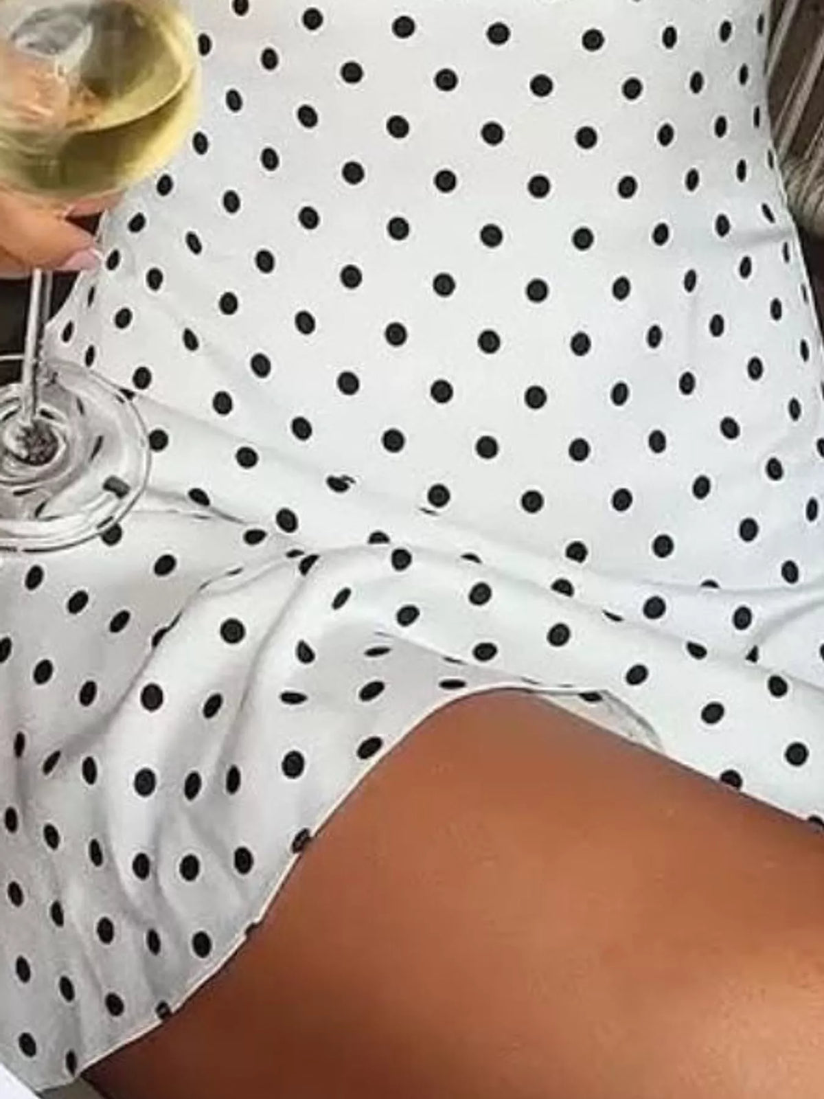 White halter mini dress with black polka dots and ruffled layered hem